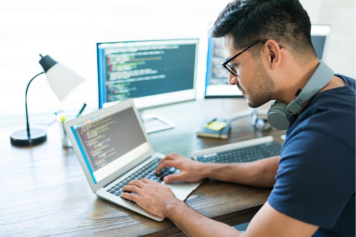 person coding on a laptop