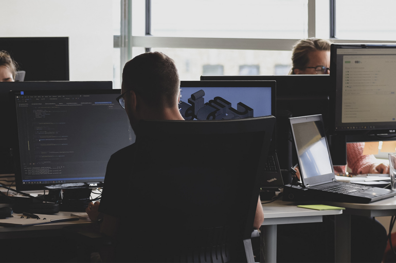 A Microsoft Azure administrator works on the cloud in an office.